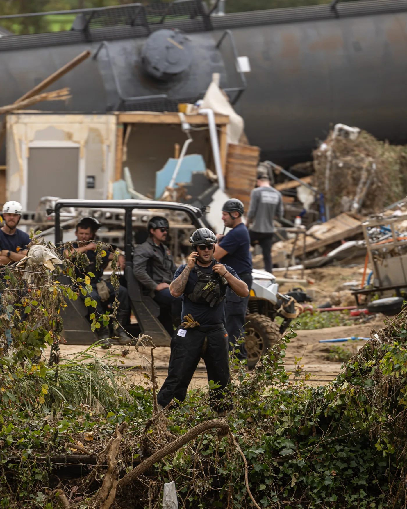 Responders working a flood-damaged debris field